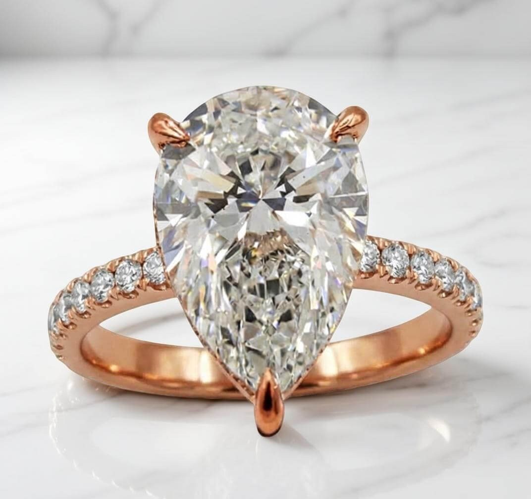 Rose gold pear lab diamond engagement ring with diamond band