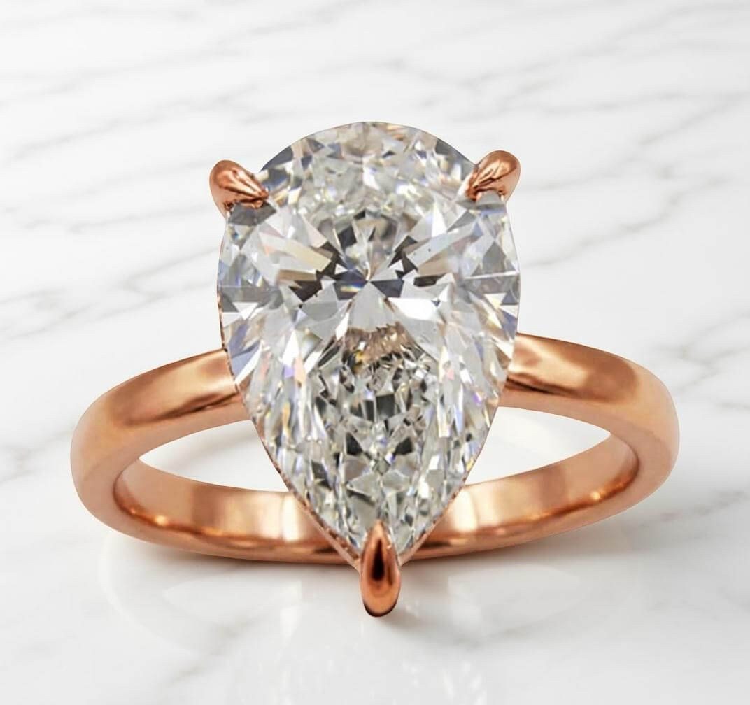 Rose gold pear-shape lab diamond engagement ring with plain band