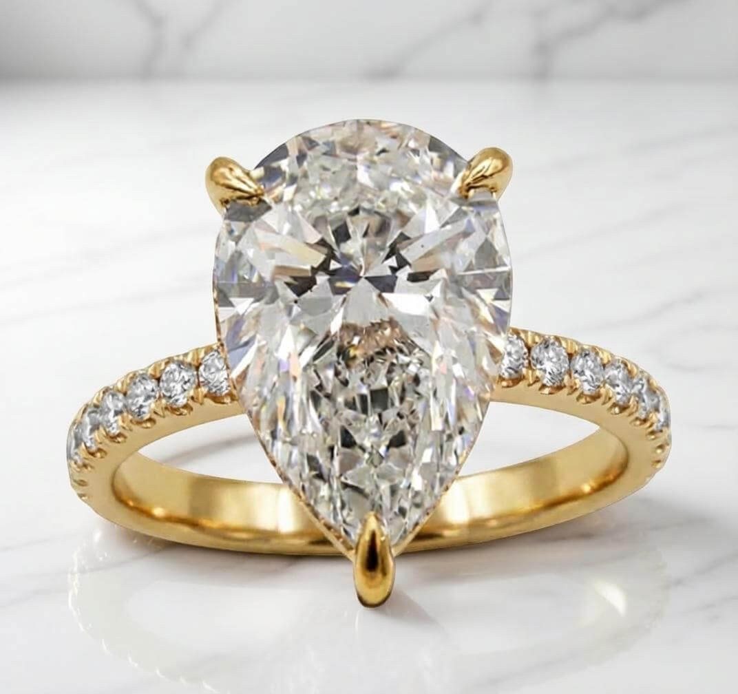Yellow gold pear lab diamond engagement ring with hidden halo